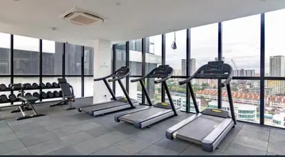 a gym with treadmills and ellipticals in a building at Wanderlust Retreat 3R by Urban Suites in George Town