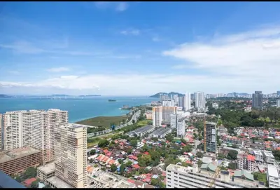 an aerial view of a city with buildings and the ocean at Wanderlust Retreat 3R by Urban Suites in George Town