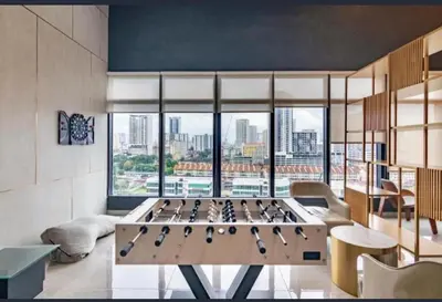a room with a large foosball table in front of a window at Wanderlust Retreat 3R by Urban Suites in George Town