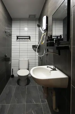a bathroom with a white toilet and a sink at The Cintra Muse Hotel at Central of Georgetown and UNESCO in George Town