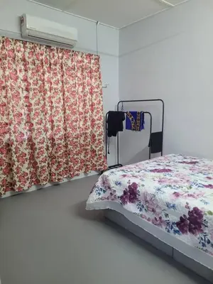 a bedroom with a bed and a curtain at BUDI HOMESTAY Meru Jaya in Ipoh