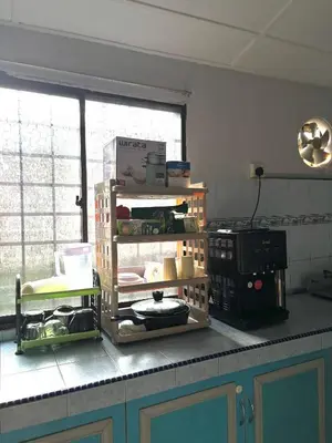 a kitchen with a counter with alot of items on it at BUDI HOMESTAY Meru Jaya in Ipoh