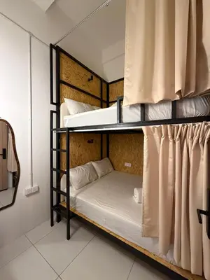 two bunk beds in a room with a curtain at Amore Stay by BNB4U in George Town