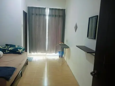 a bedroom with a bed and a window with curtains at HomeStay YNS Kampar Putra Perak 2 Bilik dan 2 Bilik Air in Kampar