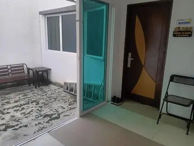 a door to a room with a bench and a window at HomeStay YNS Kampar Putra Perak 2 Bilik dan 2 Bilik Air in Kampar