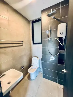 a bathroom with a toilet and a shower and a sink at Urban Suites 3R2B 11pax Deluxe Living Room in George Town
