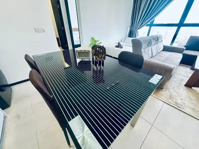 a dining table in a living room with a couch at Urban Suites 3R2B 11pax Deluxe Living Room in George Town