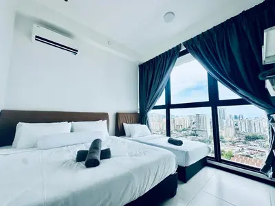 two beds in a room with a large window at Urban Suites 3R2B 11pax Deluxe Living Room in George Town