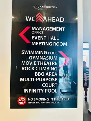 a sign for amanagement office event hall meeting room at Urban Suites 3R2B 11pax Deluxe Living Room in George Town