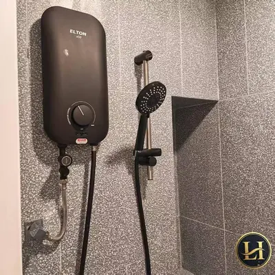 a shower in a bathroom with a hair dryer at The Stallionz Classy Suites by LH - Ipoh Town in Ipoh