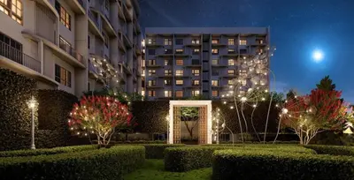 a building at night with bushes and trees and lights at Stallionz by KLIQ in Ipoh
