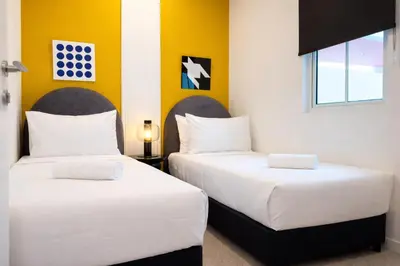 two beds sitting next to each other in a room at Stallionz Ipoh by ANGO in Ipoh