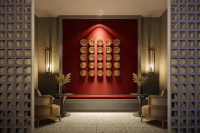 a room with a red wall with a painting on the wall at Stallionz Leisure Suites Ipoh in Ipoh