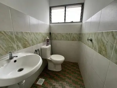a bathroom with a sink and a toilet and a window at LAMAN SUZY Seri Iskandar in Seri Iskandar