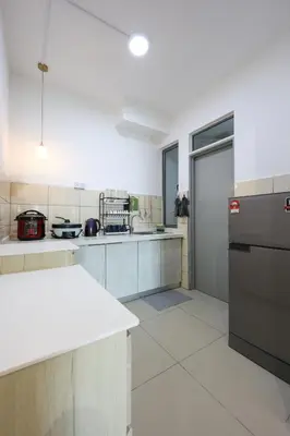 a large kitchen with white counter tops and appliances at Muji Style Top 5 Palas Horizon Brinchang Cameron Highlands - C Home Luxury A-5-04 in Brinchang