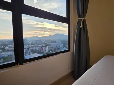 a bedroom window with a view of a city at Piccadilly Greentown Ipoh in Ipoh