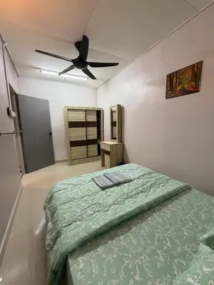 a bedroom with a bed and a ceiling fan at PRS Homestay in Chemor