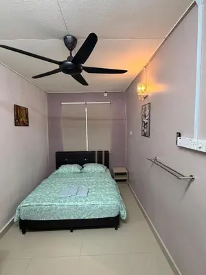 a bedroom with a bed with a ceiling fan at PRS Homestay in Chemor