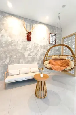 a living room with a couch and a hanging bed at Ipoh Santorini Pool Villa 4BR 15pax by One Life Four Season Guesthouse in Ipoh