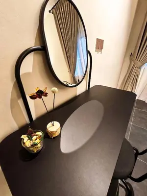 a black table with a mirror on the wall at Ipoh Santorini Pool Villa 4BR 15pax by One Life Four Season Guesthouse in Ipoh