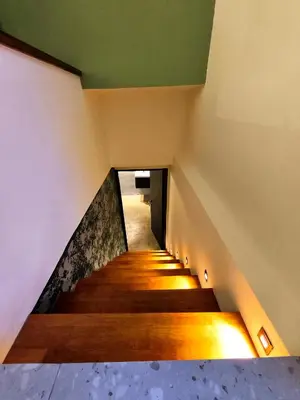 a staircase with wooden floors and a green ceiling at Ipoh Santorini Pool Villa 4BR 15pax by One Life Four Season Guesthouse in Ipoh