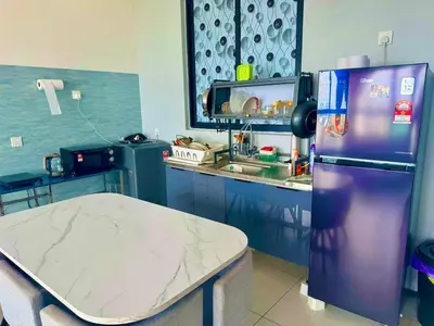 a kitchen with a purple refrigerator and a counter at Luxury 3BRHighFloor CityView10 Pax StylishSpacious in George Town