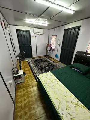 a bedroom with a bed and a shower in it at Teratak Kasih Kabinstay in Tanjung Karang