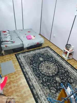 a room with two beds and a rug at Teratak Kasih Kabinstay in Tanjung Karang