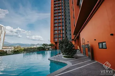a large swimming pool next to a tall building at Ipoh Town Piccadilly Premium Suites by Verve 3B2B in Gua Sai