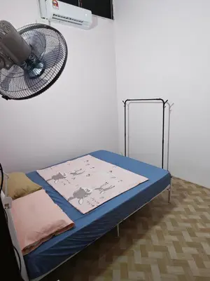 a bed in a room with a basket on the wall at Yoland Homestay Baling Kedah in Baling