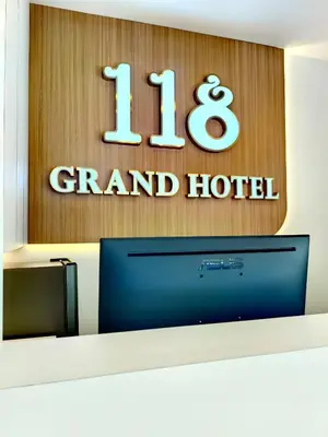 a sign for a grand hotel with a television at 118 Grand Hotel in George Town