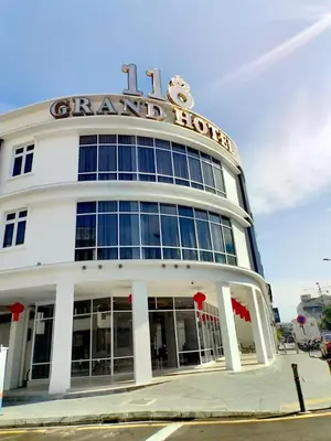 a white building with a sign on top of it at 118 Grand Hotel in George Town