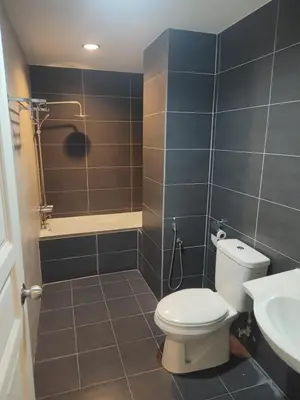 a bathroom with a toilet and a shower and a sink at Kinta Olive in Ipoh
