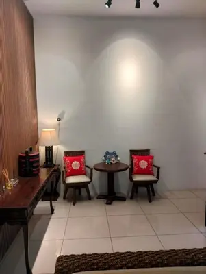 a living room with two chairs and a table at Sentosa Grand Homestay in Kulim