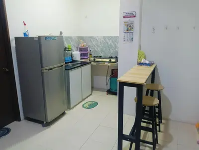 a small kitchen with a refrigerator and a counter at Room Stay YNS Kampar Putra 1 Bilik dan Bilik Air in Kampar