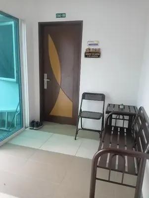 a waiting room with two chairs and a door at Room Stay YNS Kampar Putra 1 Bilik dan Bilik Air in Kampar