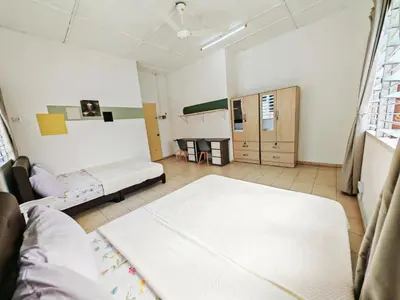a large room with two beds and a table at Spacious 9 Rooms house 23paxQbay MallSpice Arena in Gelugor