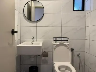 a bathroom with a sink and a toilet and a mirror at N0ir Blanc Piccadilly Ipoh Town 3R2B 6-7pax in Ipoh