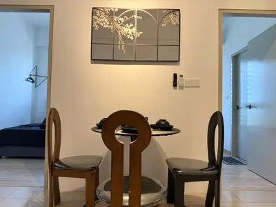 a dining room with two chairs and a table at N0ir Blanc Piccadilly Ipoh Town 3R2B 6-7pax in Ipoh