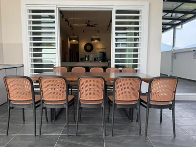 a dining room with a wooden table and chairs at Rustic Vibe Pool Bungalow Karaoke 5R7B for 22pax in Ipoh