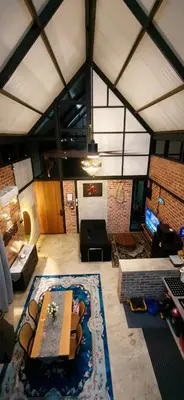 a living room with a table and a couch at Sekinchan Tiny House in Sekincan