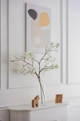 a white table with a vase of flowers on it at Serene Minimalist Family Retreat 2-7pax 8 min to BoH in Brinchang