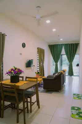 a living room with a table and a couch at Wewe Homestay CL2 in Kampung Gajah
