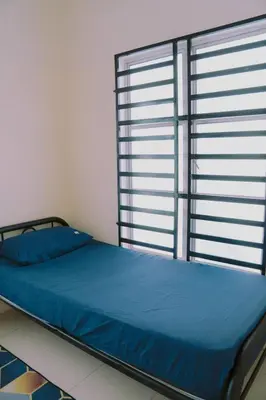 a bed in a room with a large window at Wewe Homestay CL2 in Kampung Gajah
