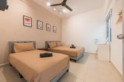 a bedroom with two beds and a window at Serene Muji Family Retreat 2-7 pax with Comfortable Living Space in Tanah Rata