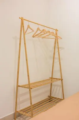 a wooden shelf with a curtain on a wall at Serene Muji Family Retreat 2-7 pax with Comfortable Living Space in Tanah Rata