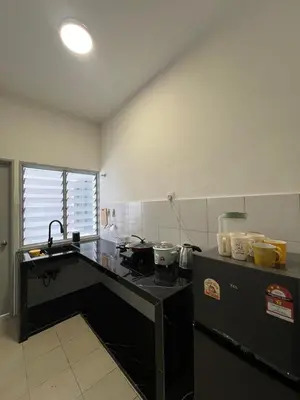 a kitchen with a stove and a counter top at Mutiara Homestay cameron in Tanah Rata