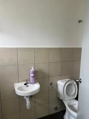 a bathroom with a toilet and a sink at Mutiara Homestay cameron in Tanah Rata