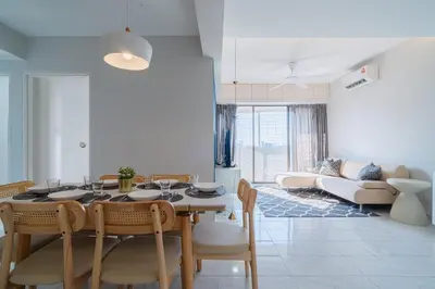 a dining room and living room with a table and chairs at Stylish 3BR Stay Near Gurney Drive Free Parking in George Town