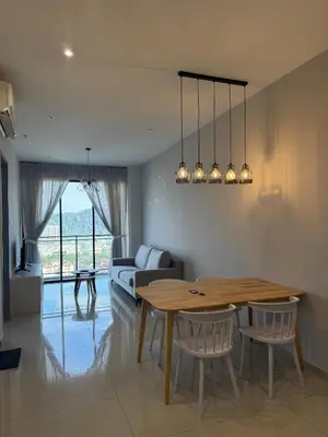a living room with a table and a couch at Homey Studio Unit Relaxing Stay at Bayan Lepas in Gua Sai